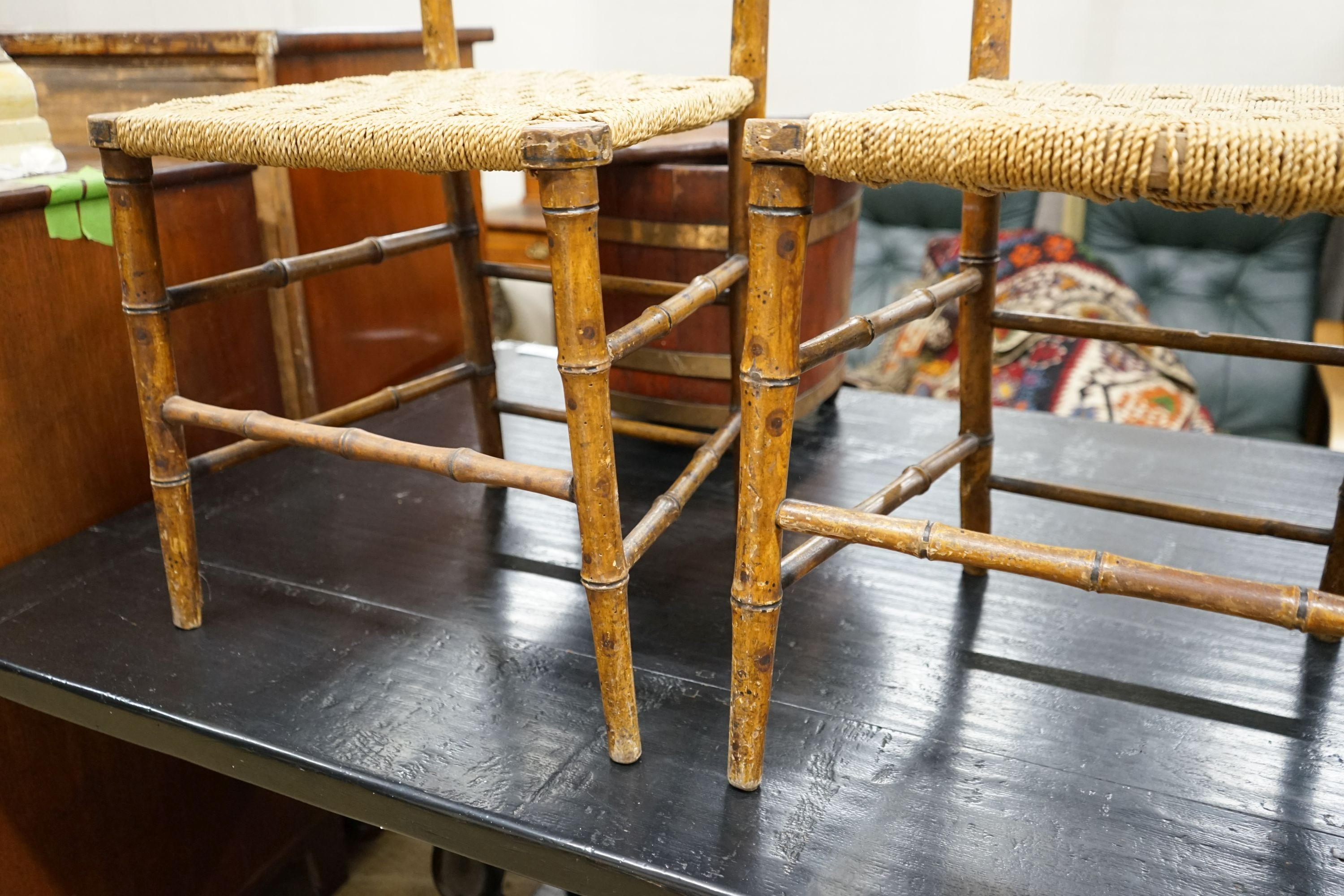 A pair of Regency faux bamboo cane seated chairs